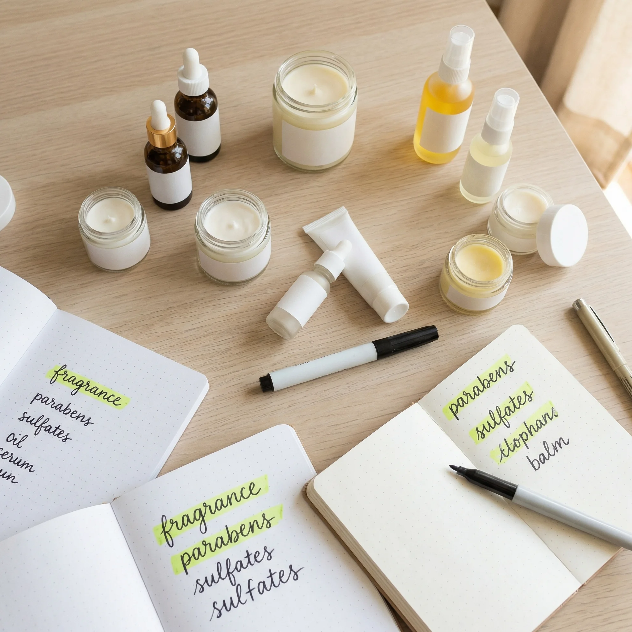 Flat lay of cosmetics with ingredient labels highlighted for safety review